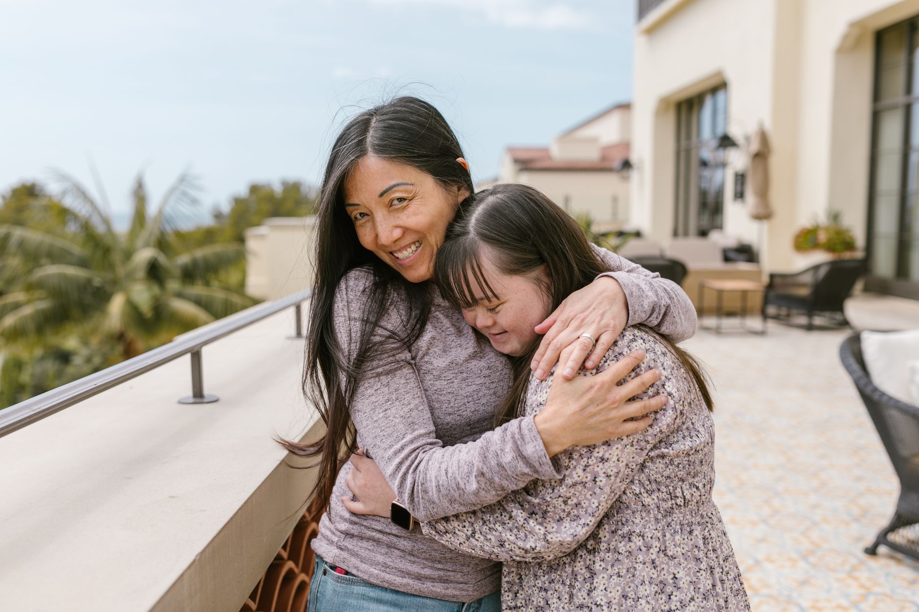 a mother hugging her daughter
